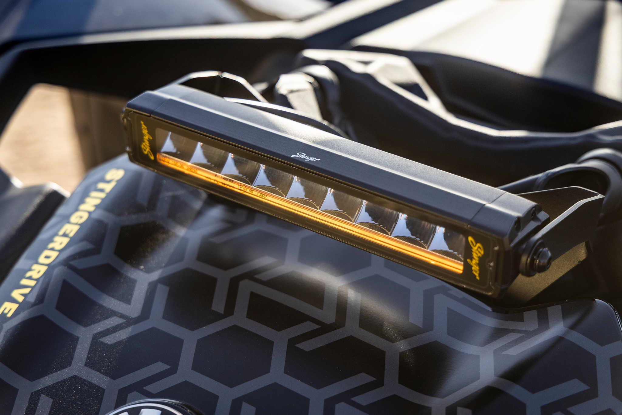 Stinger LED light bar mounted on a vehicle hood with geometric pattern