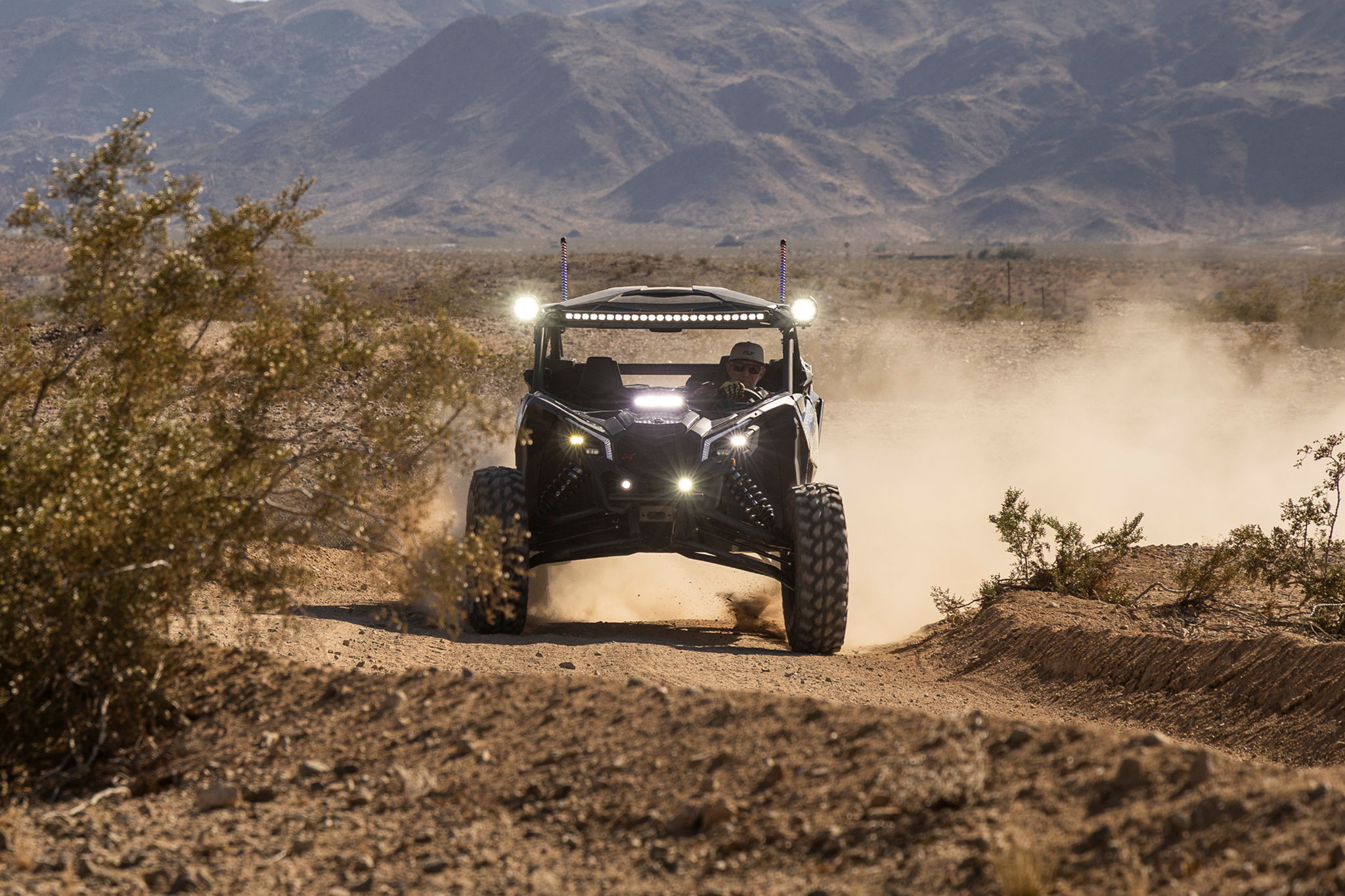 Stinger off road vehicle driving on a dusty desert trail