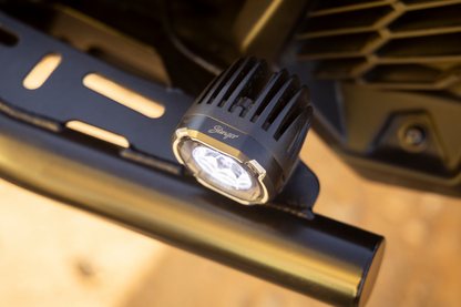 Stinger LED pod light mounted on a black metal vehicle bumper
