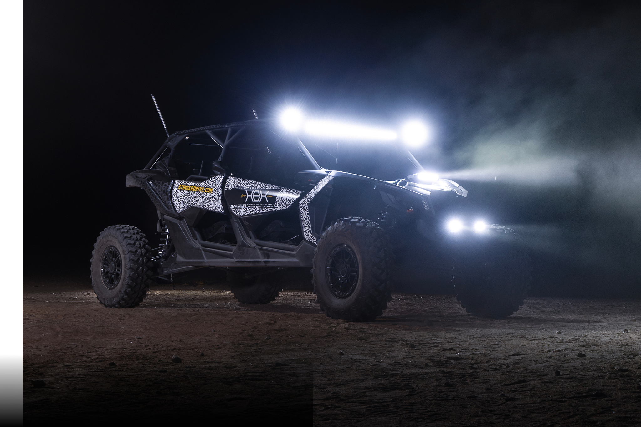 Off-road vehicle with bright lights on a dark background